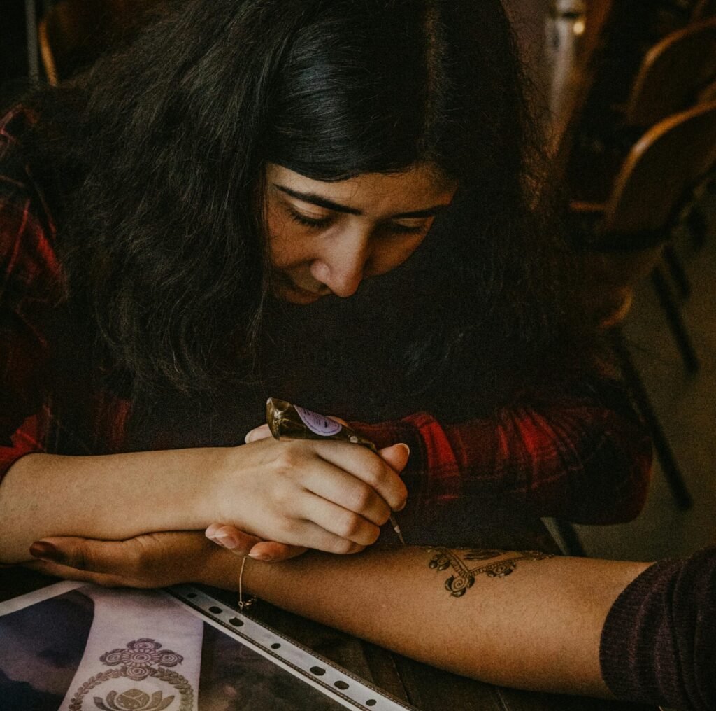 Henna artist creating beautiful arm patterns at an event in Berlin, Germany.