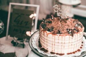 Beautiful bridal cake with chocolate toppings and caramel drizzle, perfect for celebrations.