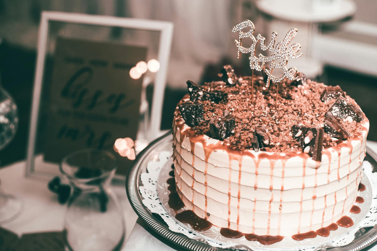 Beautiful bridal cake with chocolate toppings and caramel drizzle, perfect for celebrations.